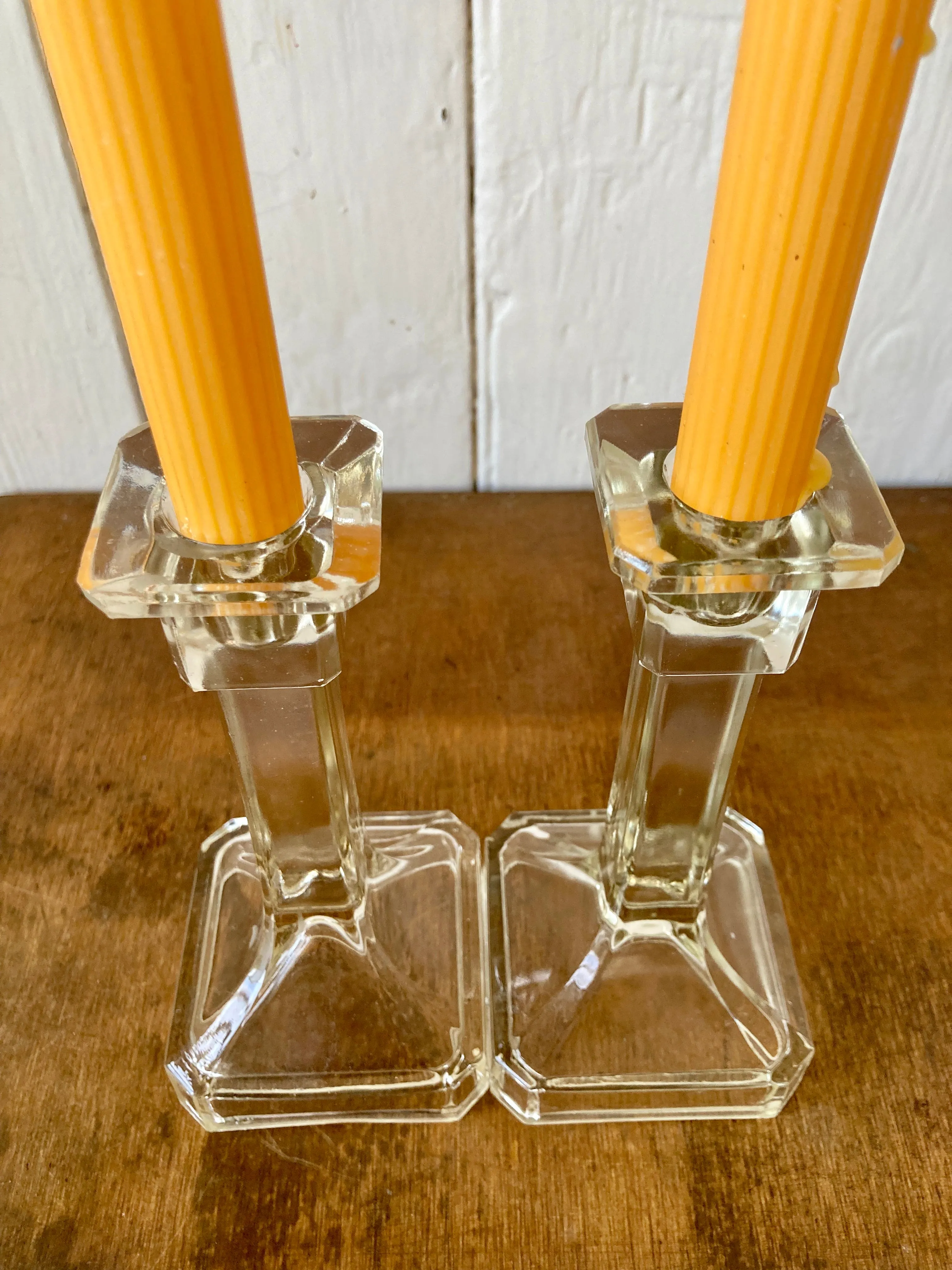 An elegant pair of clear pressed glass candlesticks