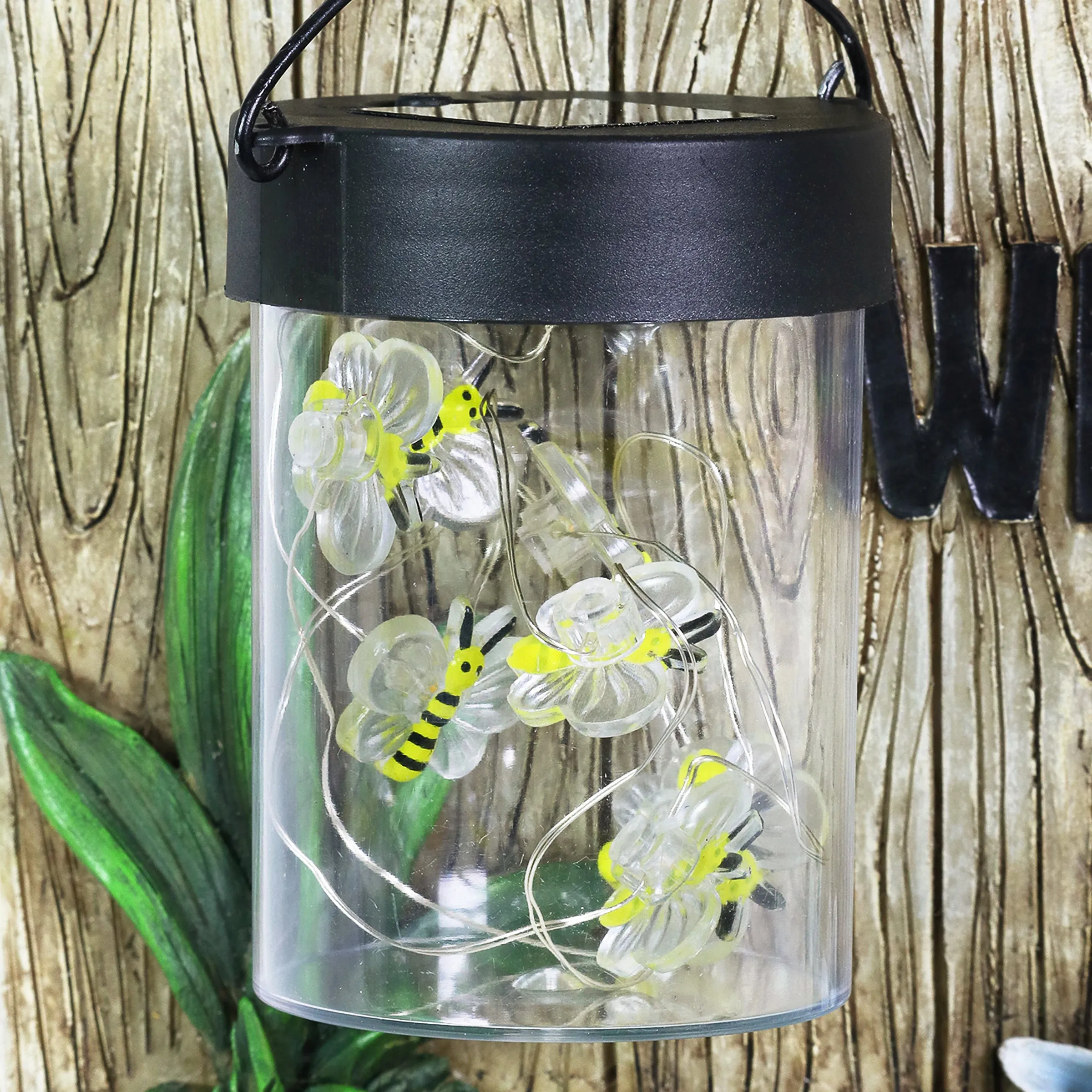 Solar Hand Painted Fox Garden Statue with a Lantern Jar of LED Bumblebees by a Welcome Fence, 9.5 by 11 Inches